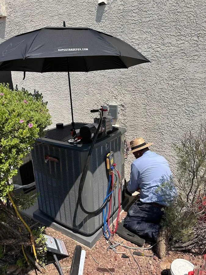 HVAC technician performing outdoor AC maintenance in Upper Hanover