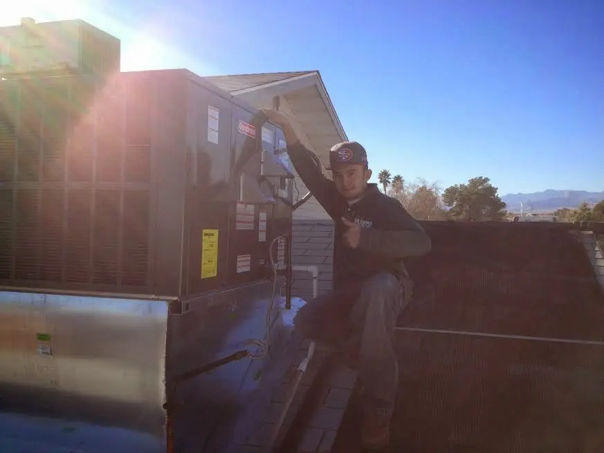 HVAC technician performing AC Tune-Up on a rooftop unit in Upper Hanover